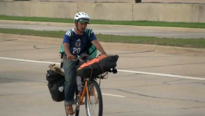 japanese student see football match on bicycle